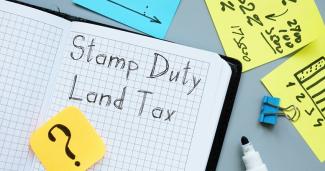Open book with text that reads Stamp Duty Land Tax