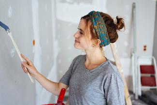 Woman painting a wall