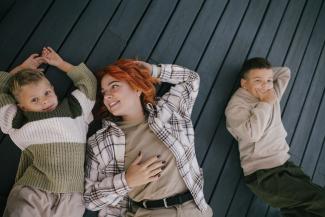 Mother with two boys lying next to her